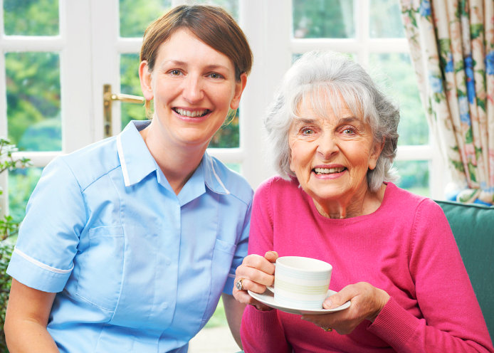 caregiver and old woman smiling